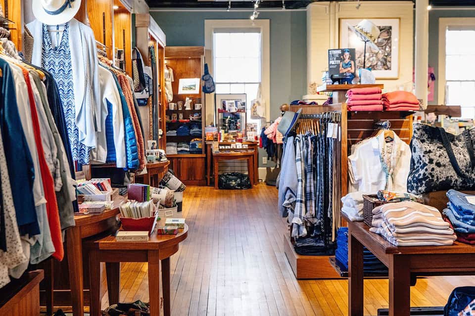 Upscale resort boutique shop displaying clothing, accessories, and merchandise displays