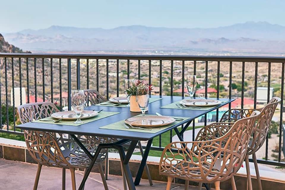 Elegant dining table on a mountain-view terrace with panoramic valley landscape