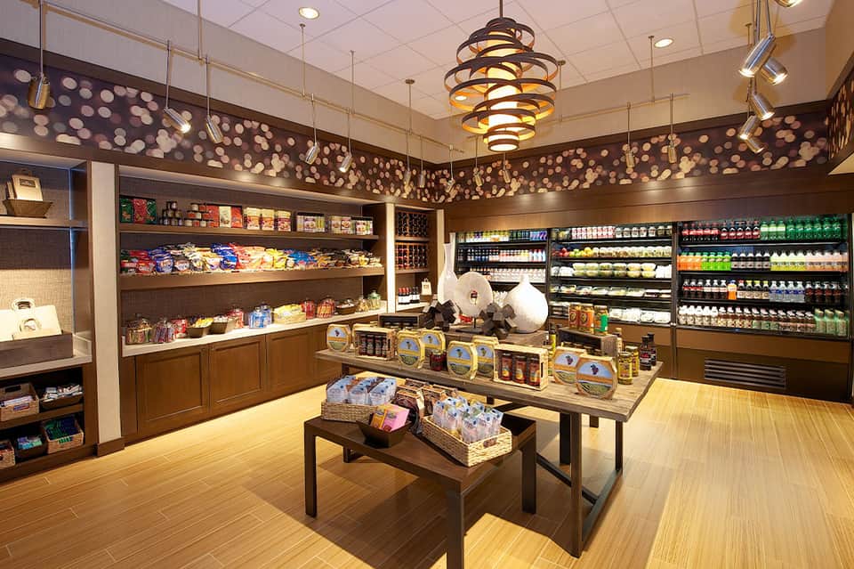 Modern resort convenience store with shelving, refrigerated goods, and products display