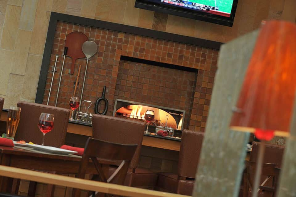 Modern fireplace lounge area with brown leather seating and mounted television