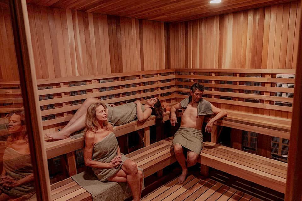 Wooden sauna interior with benches where guests relax and socialize