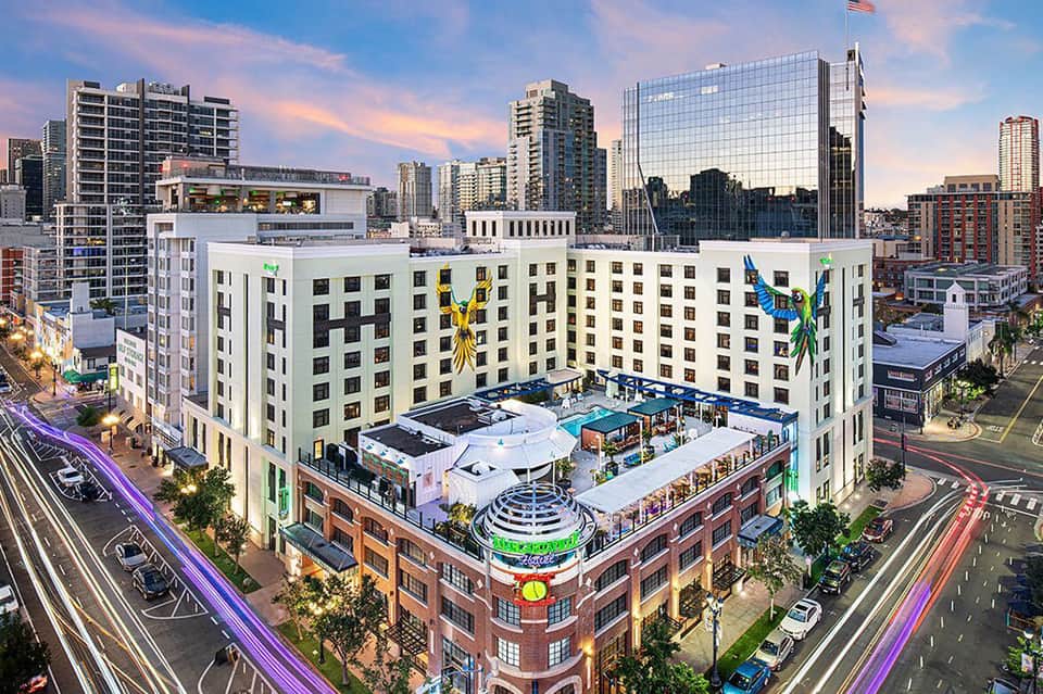 Urban rooftop pool and lounge at modern city hotel with skyline views and colorful art installations