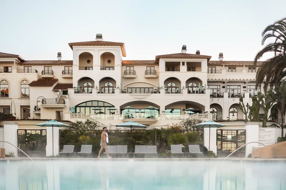 Elegant beachfront resort with Spanish architecture and infinity pool overlooking ocean