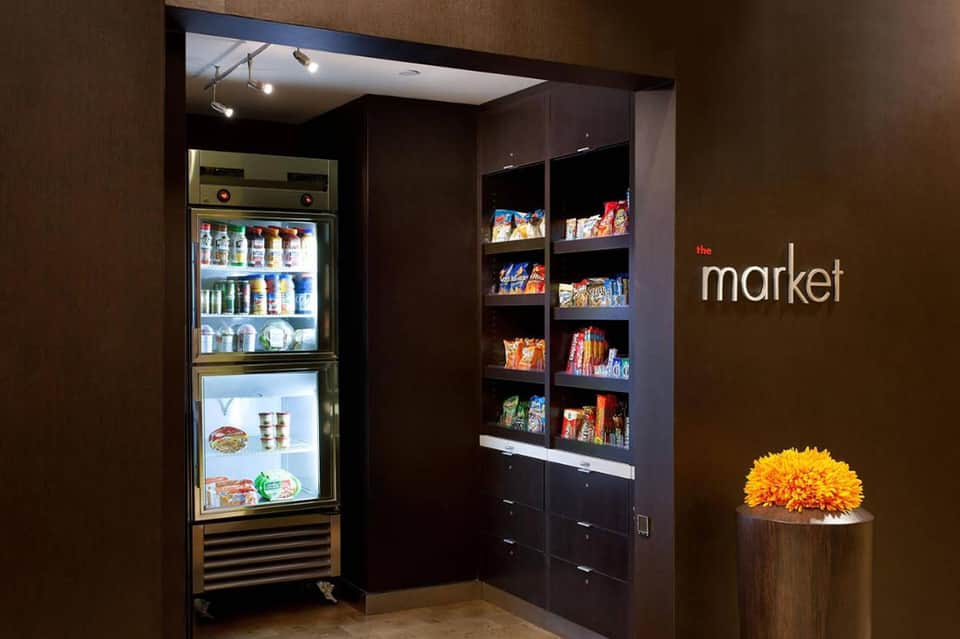 Hotel market area with refrigerated beverage display and stocked snack shelves