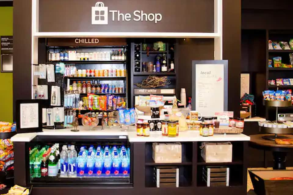 Resort shop counter displaying beverages, snacks, and retail merchandise