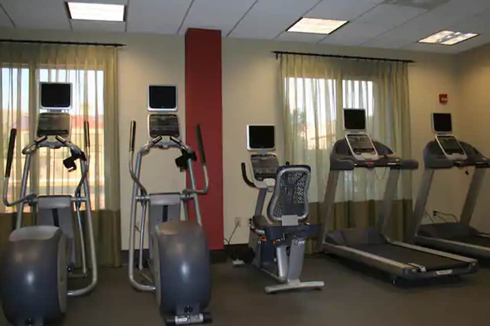 Hotel fitness center with cardio equipment including elliptical machines and treadmill