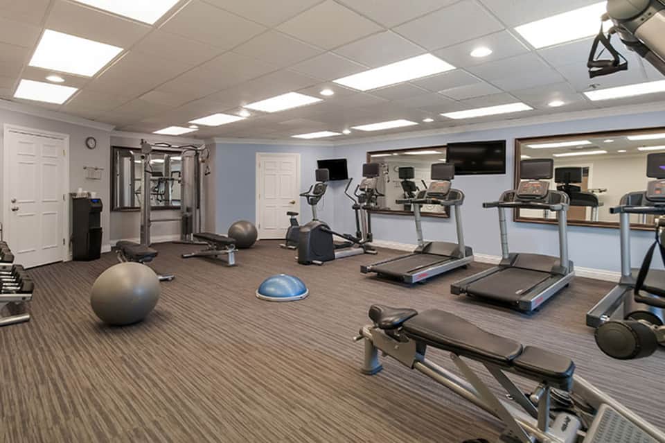 Indoor fitness center with treadmills, exercise equipment, and stability balls