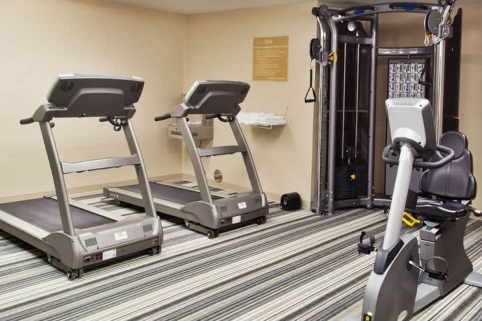 Fitness center with treadmills and exercise equipment on striped flooring