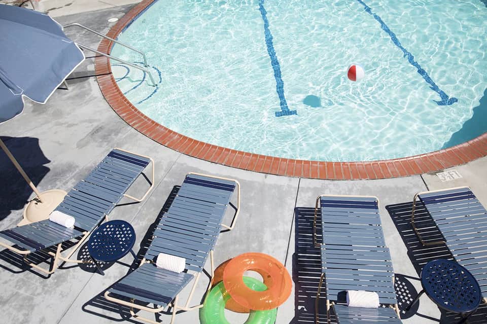 Overhead view of resort pool with lane dividers and loungers beside deck