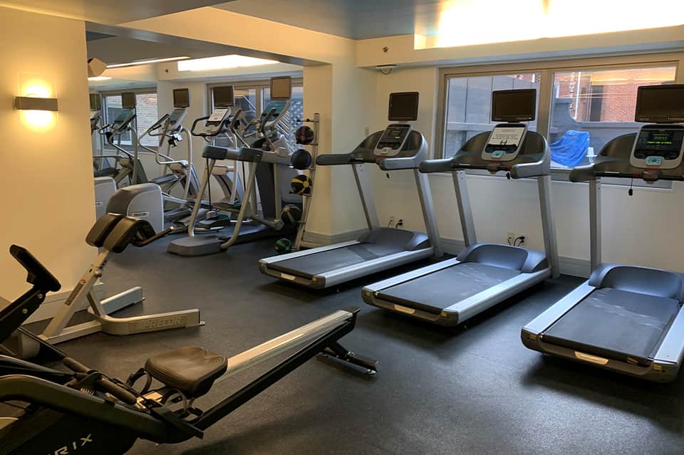 Fitness center with treadmills, stationary bikes, and exercise equipment