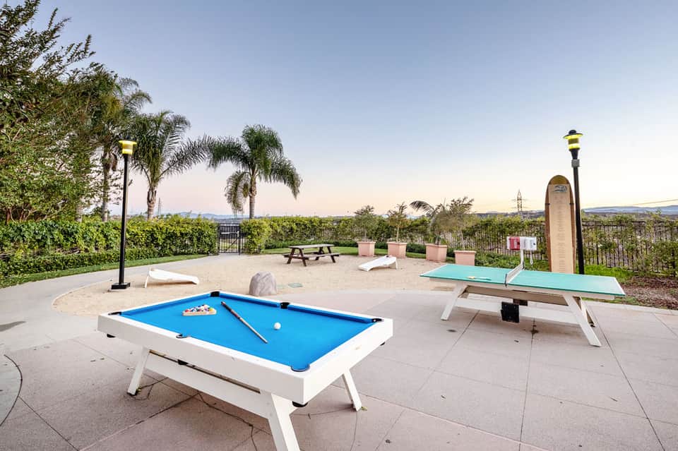 Outdoor recreation area with pool table, ping pong table, picnic seating, and scenic hillside views