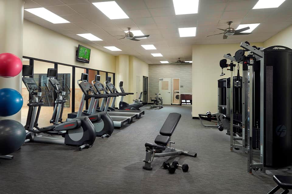 Fitness center with cardio equipment, treadmills, exercise machines, and fitness amenities