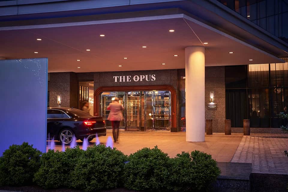 The Opus restaurant entrance at night with illuminated signage and elegant entrance portico