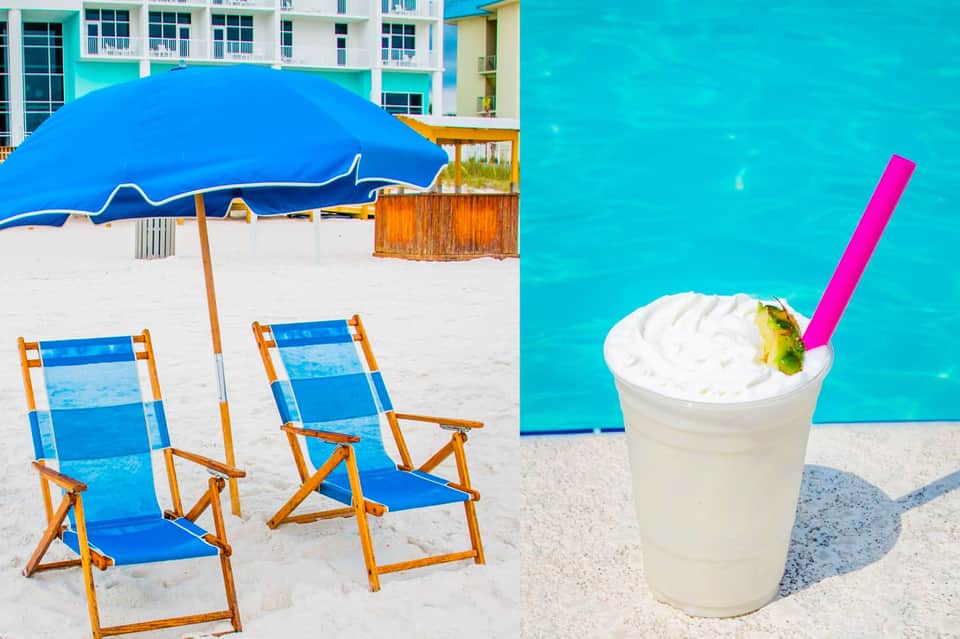 Beach chairs and blue umbrella on white sand with tropical drink and turquoise ocean water