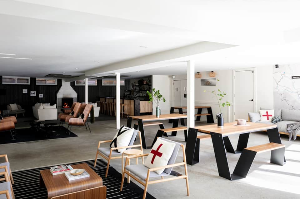 Contemporary hotel lounge with fireplace, wood furniture, and modern decor