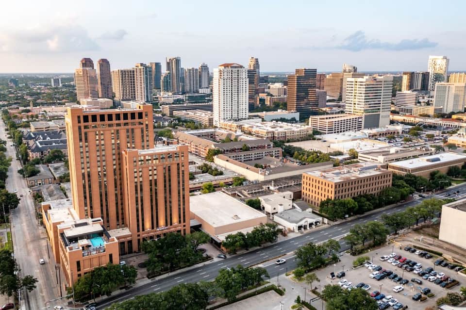 Urban cityscape with downtown skyline, brick buildings, and river
