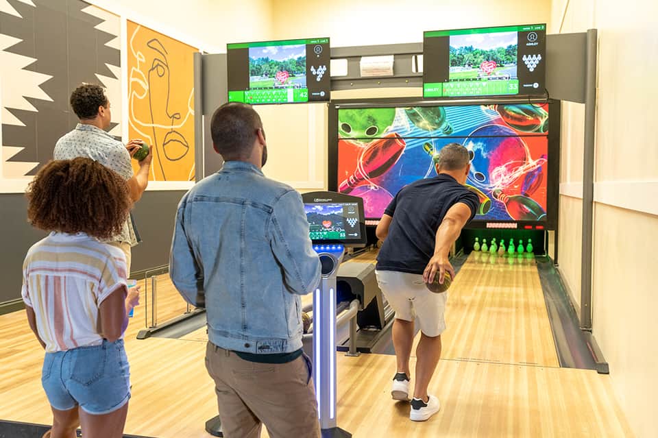 Family-friendly game room with arcade bowling game and vintage arcade machines