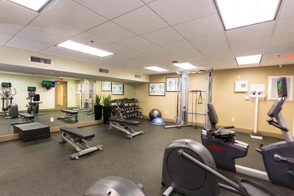 Hotel fitness center with cardio equipment, weights, and exercise machines