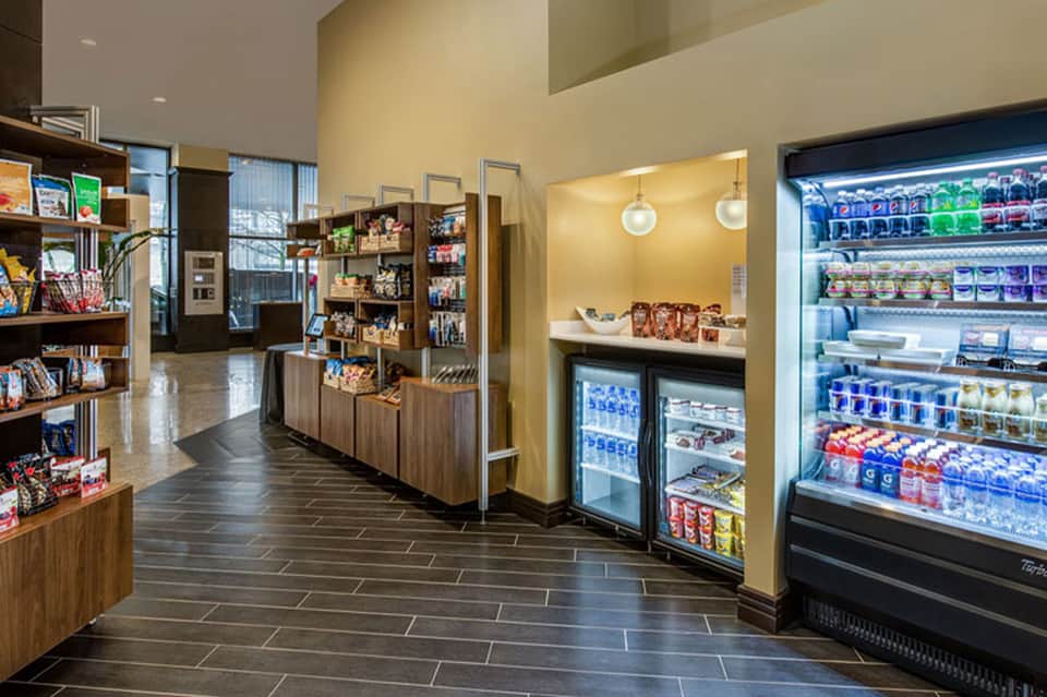 Hotel market shop interior with shelving, refrigerated beverages, snacks, and merchandise displays