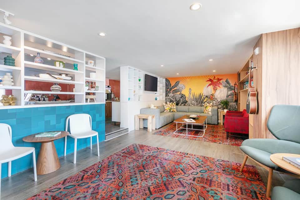 Bright hotel common area with turquoise accents and tropical decor