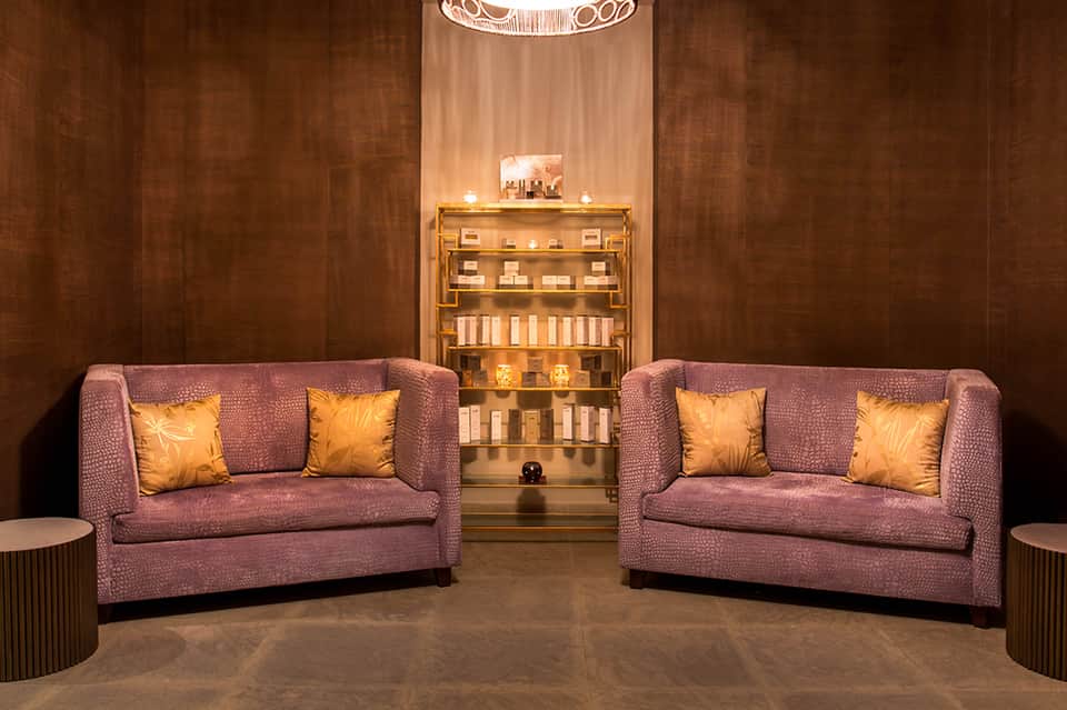Spa retail display with illuminated shelving showcasing skincare and beauty products in warm lighting