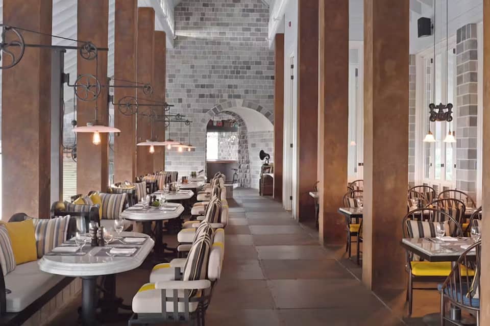 Fine dining restaurant with tall columns, arched ceilings, and elegant table settings
