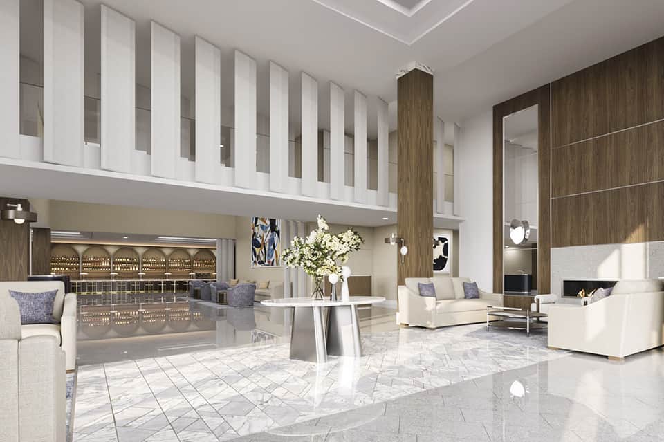 Modern luxury hotel lobby with marble floors, contemporary seating, and double-height spaces