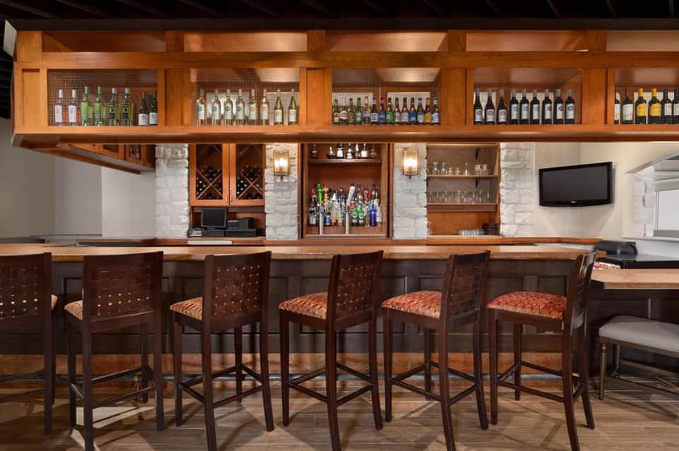Upscale wooden bar with extensive wine and spirit selection and premium seating