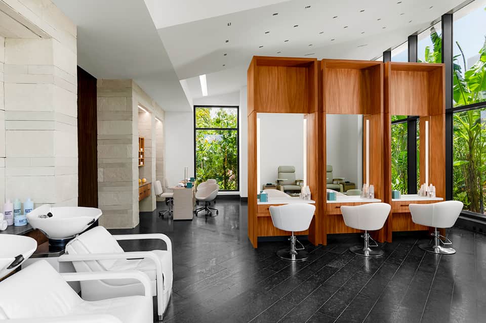 Luxury spa facility with multiple wash basins and wooden partition styling