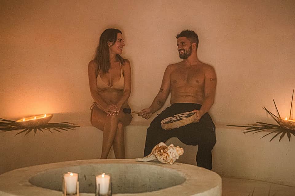 Couple relaxing in spa bath with candles and ambient lighting in luxury spa setting