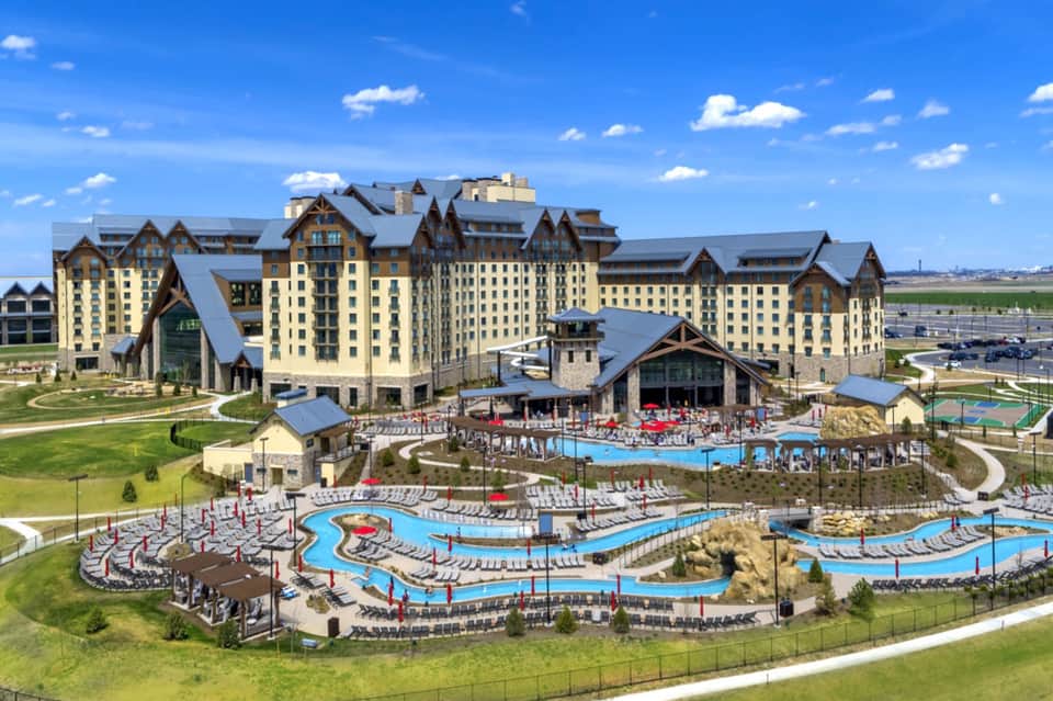 Aerial view of large castle-style resort with multiple pools and manicured grounds