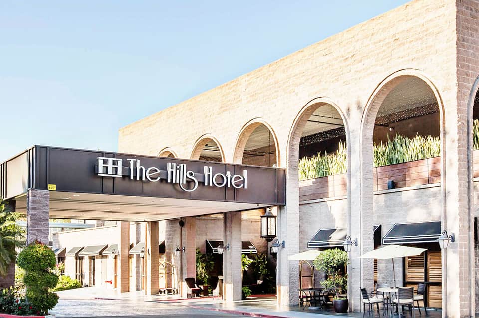 The Hills Hotel entrance with arched architectural details and modern signage