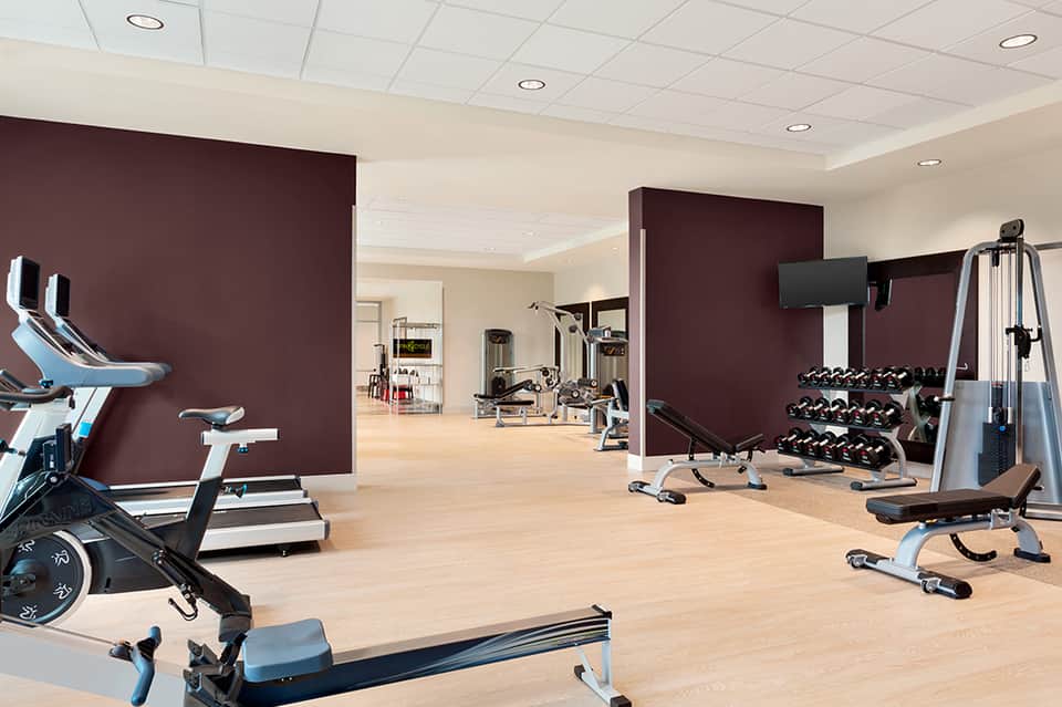 Modern fitness center with exercise bikes, weights, and gym equipment