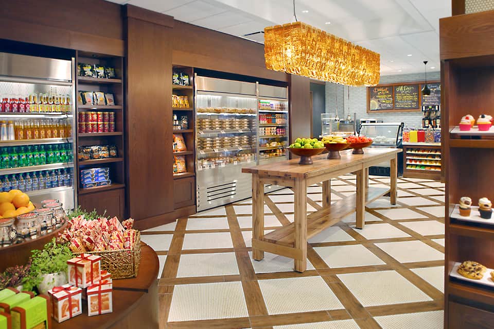 Modern bakery and café interior with wood display cases and fresh pastries on counter