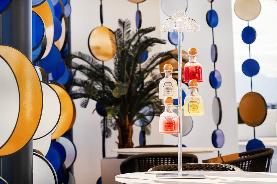 Luxury spa display with hanging perfume bottles and decorative blue and gold orbs in elegant boutique setting