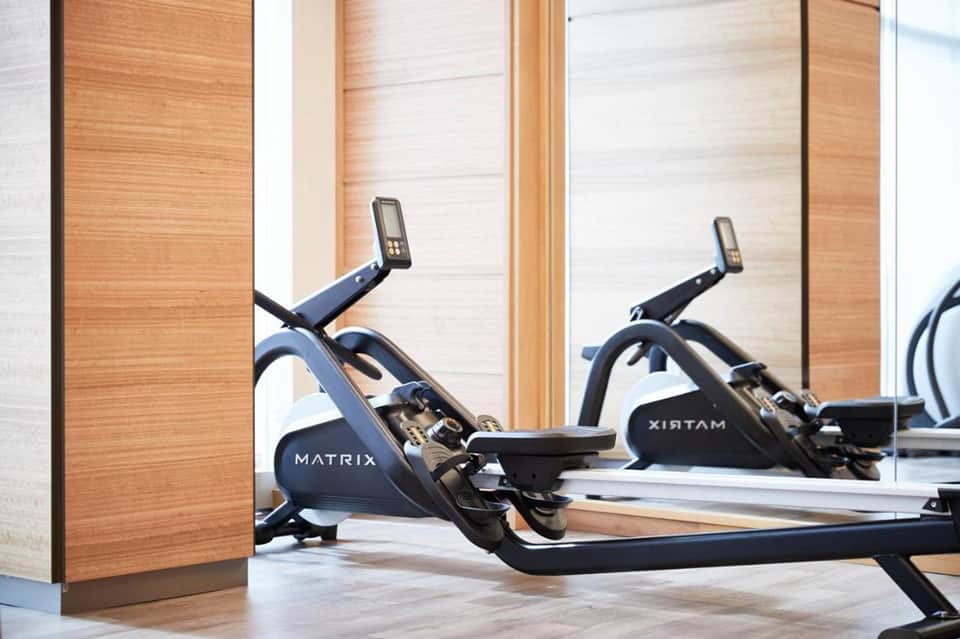 Modern fitness center with Matrix exercise bikes and wooden interior walls