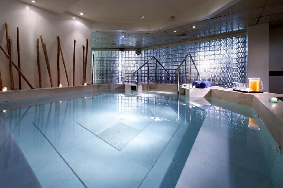 Indoor lap pool with contemporary design and geometric window patterns