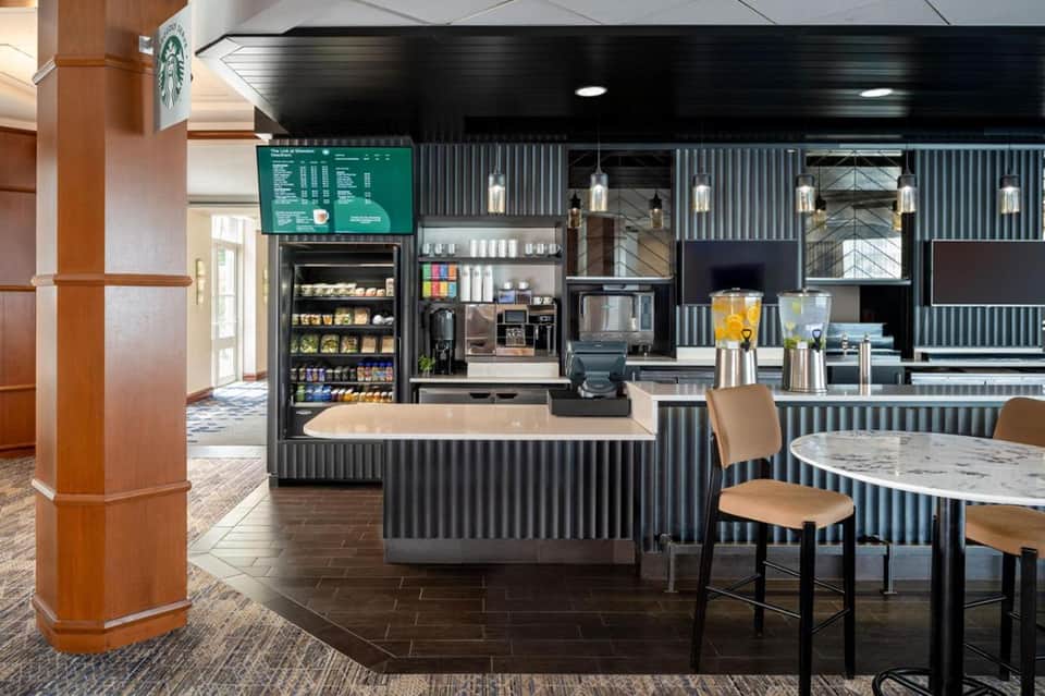 Modern Starbucks café interior with black corrugated metal counter and seating area