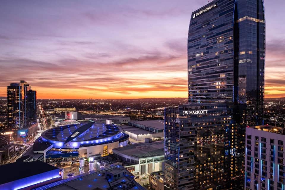 Downtown skyline at sunset with JW Marriott hotel tower and illuminated circular arena below