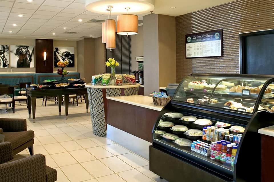 Modern café interior with pastry display case and seating areas