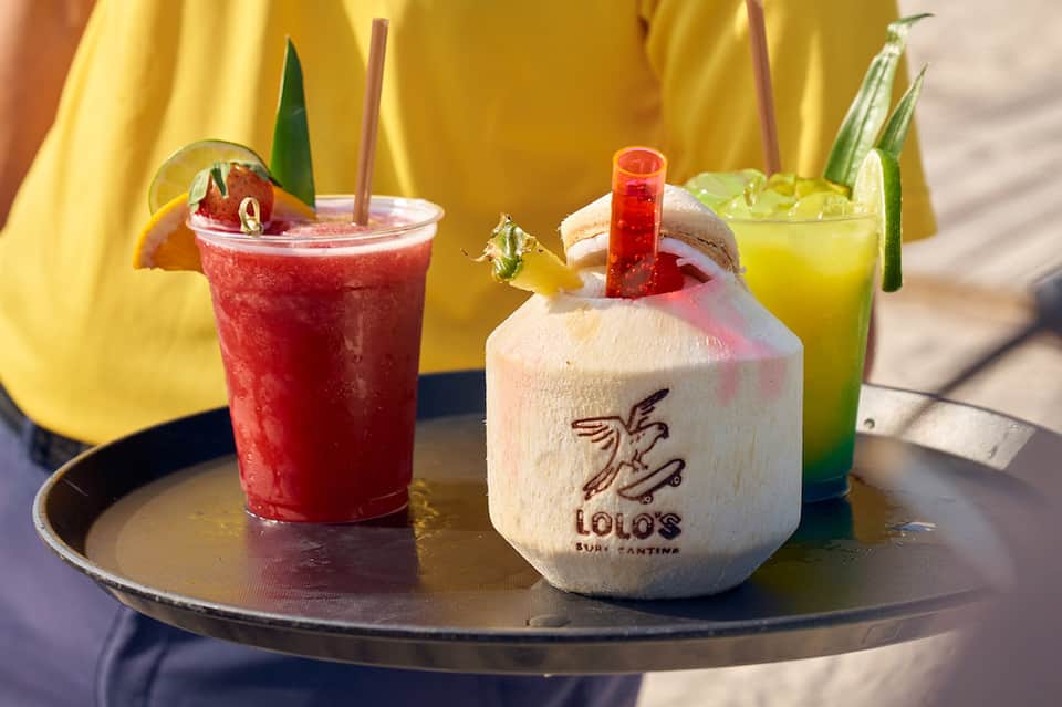 Tropical cocktails served at a resort bar with coconut drink and colorful beverages