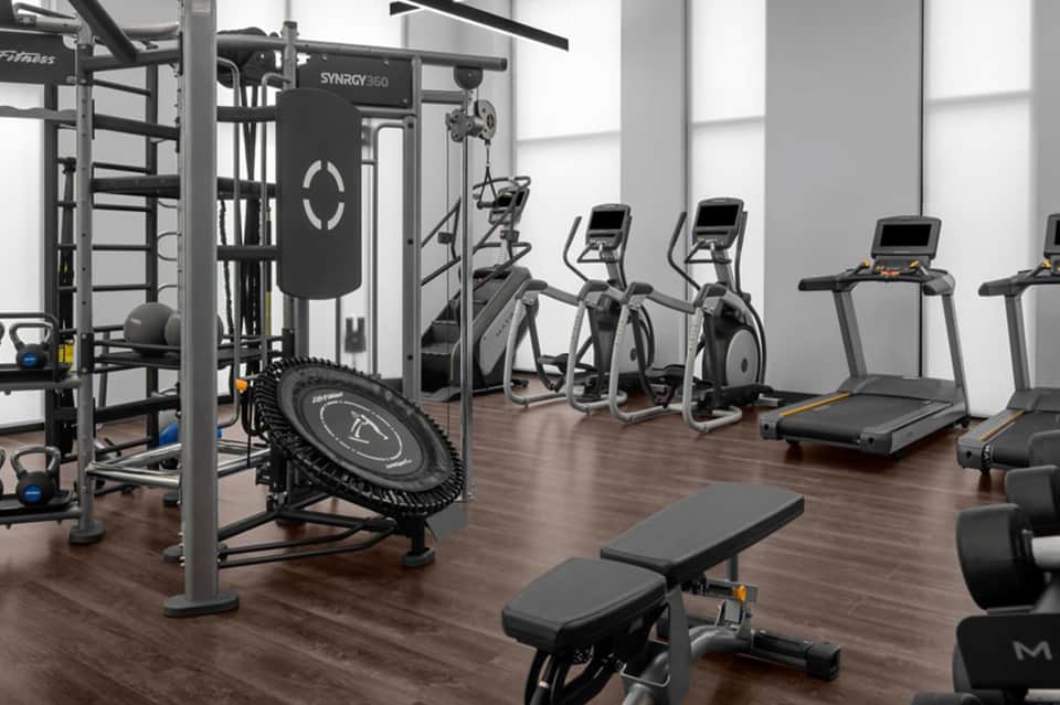 Modern fitness center with cardio equipment, weight machines, and functional training gear