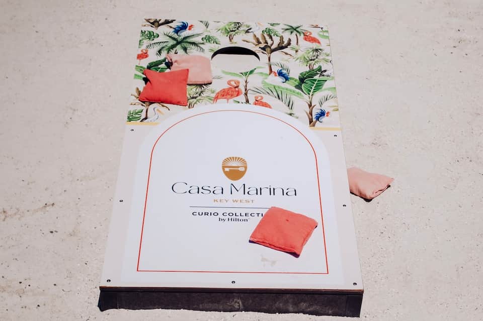 Cornhole board game with tropical bird design at Casa Marina Key West resort beach