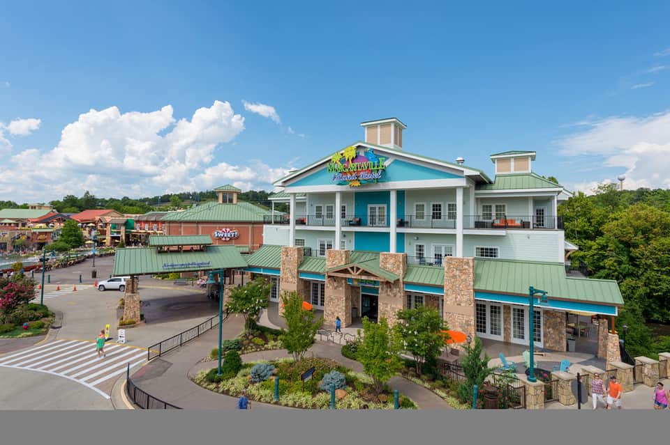Aerial view of Margaritaville resort building with turquoise and white architecture surrounded by landscaping