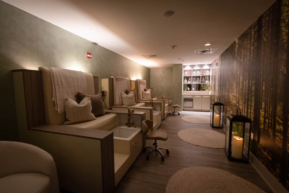 Spa relaxation room with individual massage chairs in neutral tones and ambient lighting