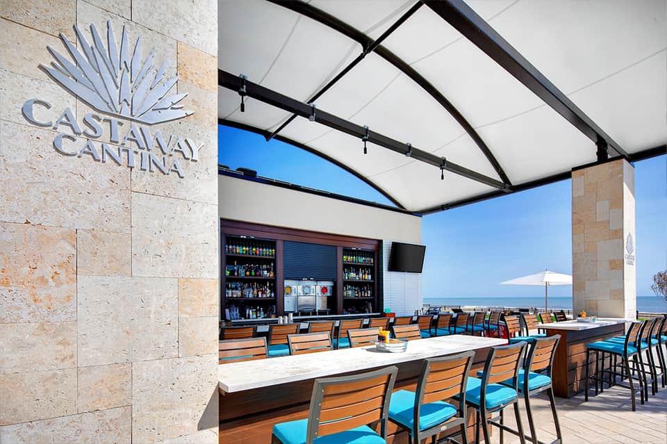 Oceanfront cantina with retractable roof, bar seating, and views of the sea