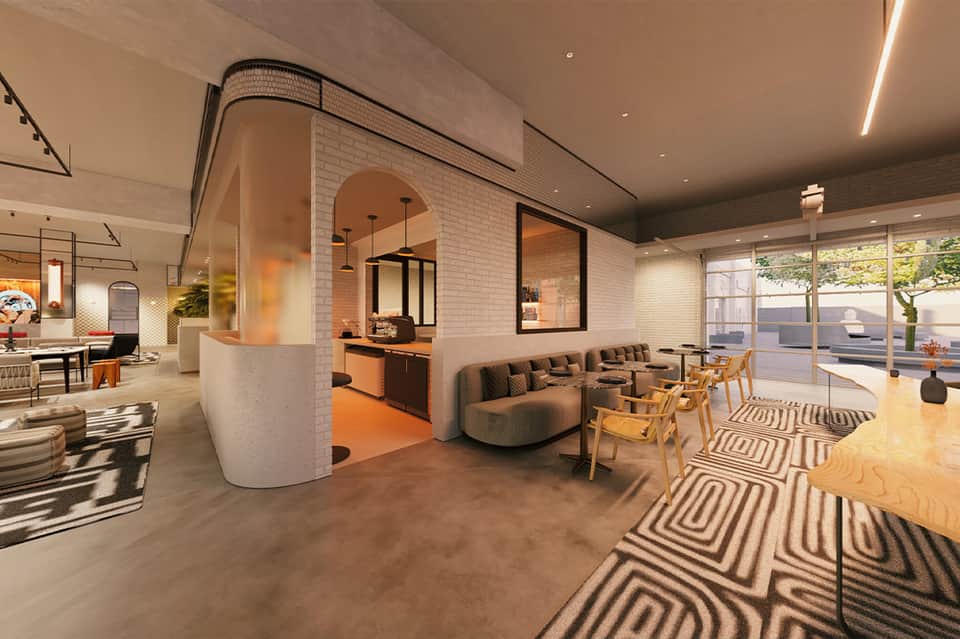 Modern hotel lobby with curved white brick walls, orange accents, and casual seating