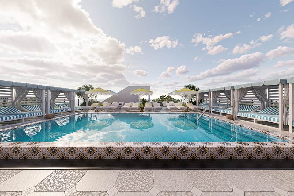Resort pool with cabanas and lounge chairs under blue sky with fluffy clouds