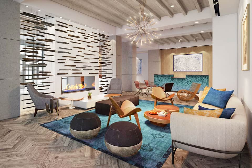 Contemporary hotel lobby with fireplace, modern furniture, turquoise accents, and artistic decor