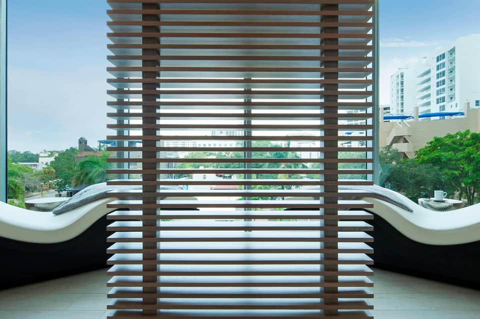 Balcony with modern slatted wood railing overlooking residential area and buildings